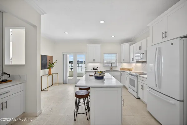 a kitchen with a refrigerator and a sink