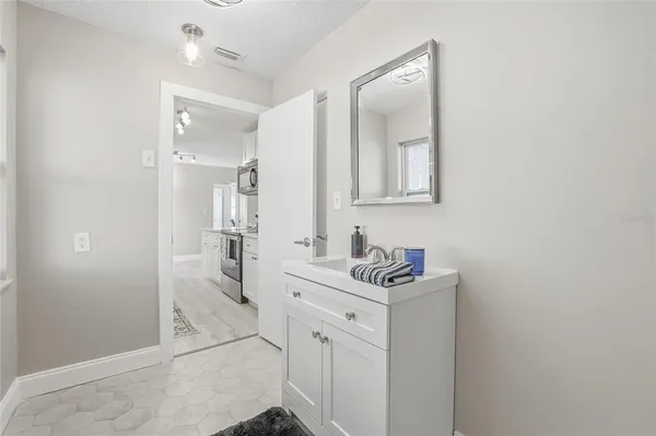 a bathroom with a sink vanity granite and a mirror