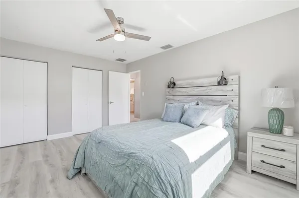 a bedroom with a bed and a chandelier