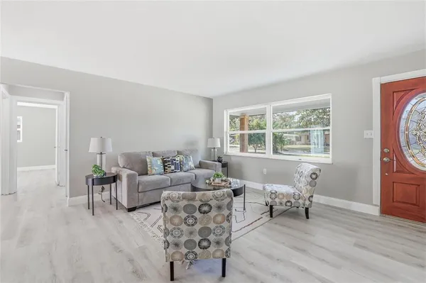 a living room with furniture and wooden floor