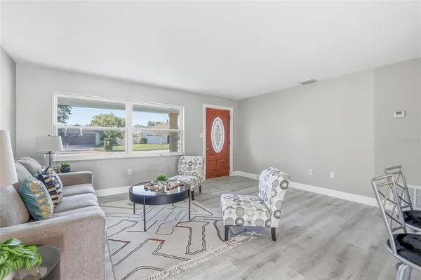 a living room with furniture and a large window