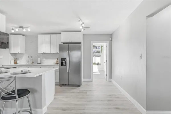 a kitchen with kitchen island a sink stove and refrigerator