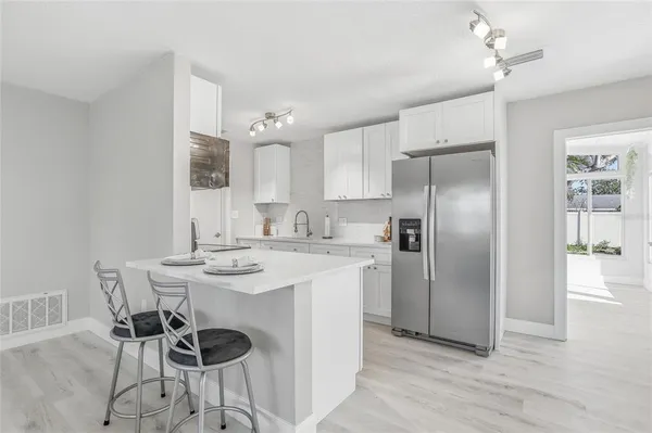 a kitchen with stainless steel appliances a sink stove and refrigerator