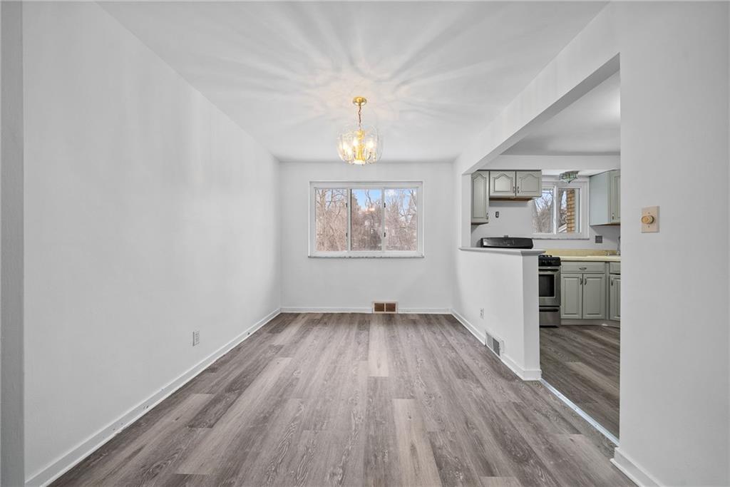 1041 Ardmore Manor Drive Pittsburgh, PA 15221 - Photo 15 of 38 wooden floor in an empty room with a window