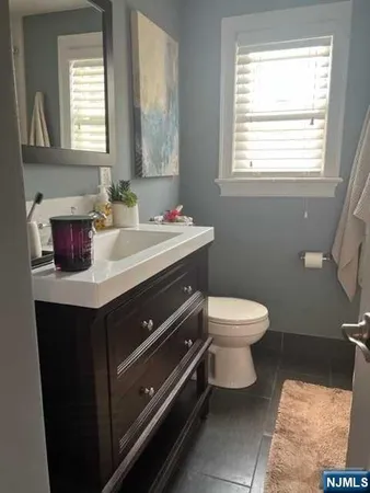 a bathroom with a sink toilet and mirror