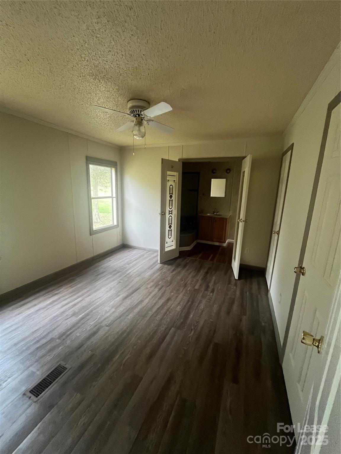 124 Saylor Lane Stony Point, NC 28678 - Photo 5 of 11 a view of empty room with wooden floor and fan