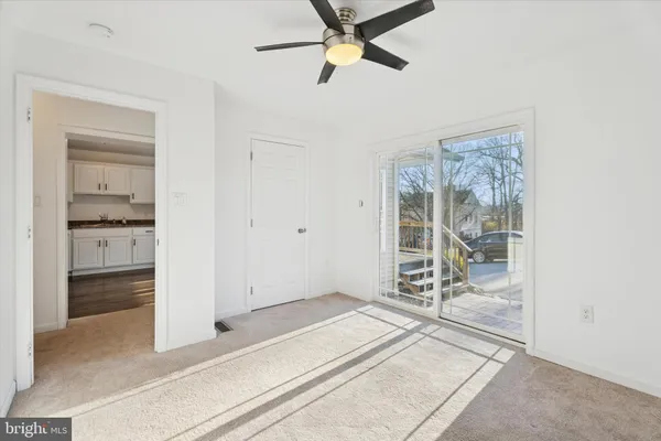 a view of a room with wooden floor and a carpet