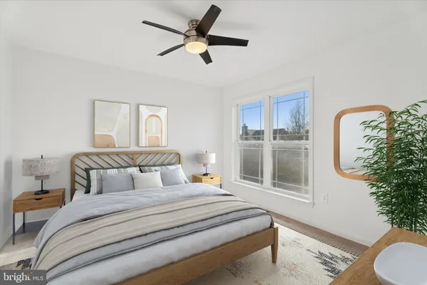 a bedroom with a large bed and a potted plant