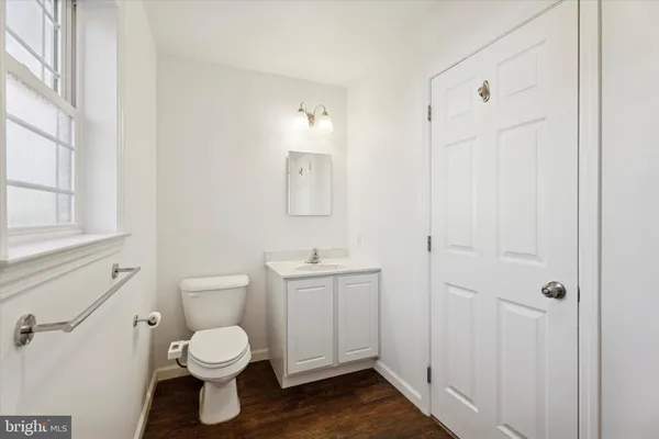 a bathroom with a toilet a sink and mirror