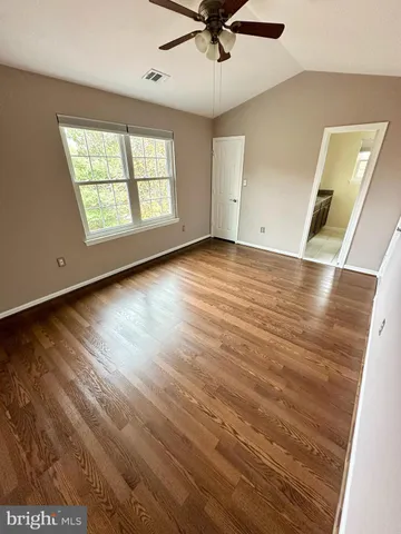 an empty room with a ceiling fan