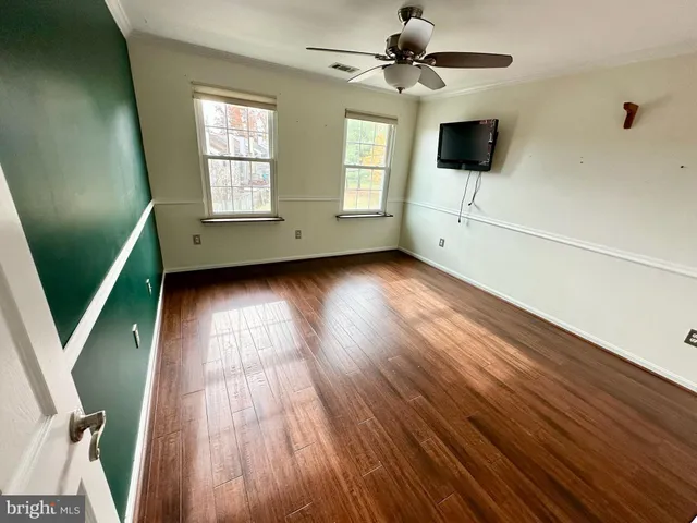 a view of an empty room with a kitchen