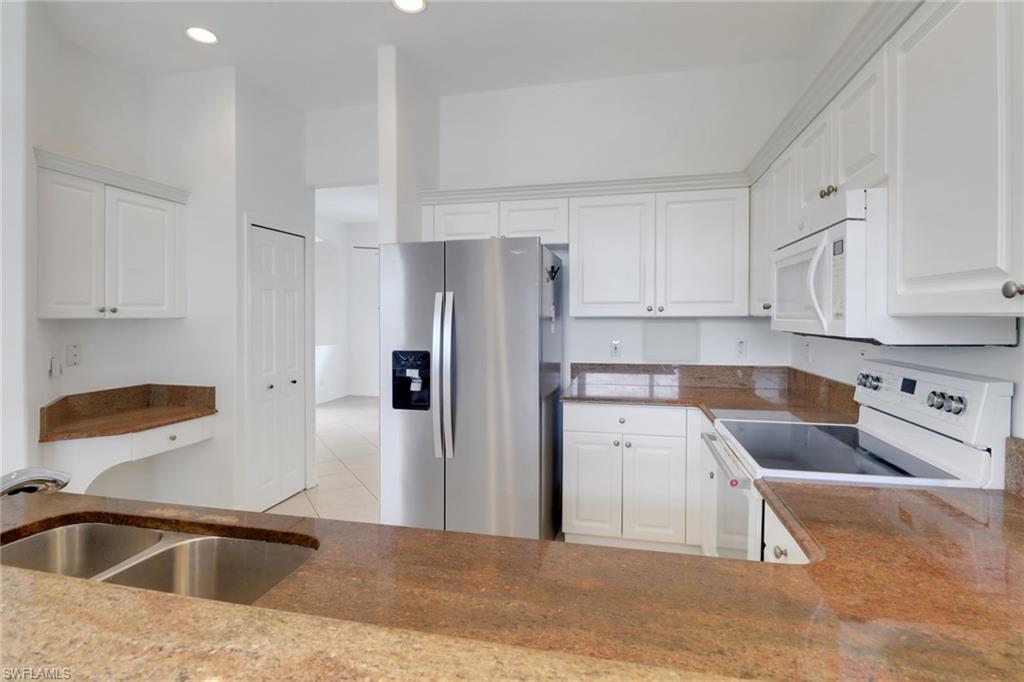 3283 Potomac Court Naples, FL 34120 - Photo 11 of 29 Kitchen featuring white cabinetry, a sink, recessed lighting, and white appliances