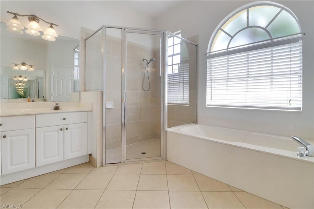 3283 Potomac Court Naples, FL 34120 - Photo 15 of 29 Full bath with vanity, tile patterned flooring, a shower stall, and a bath