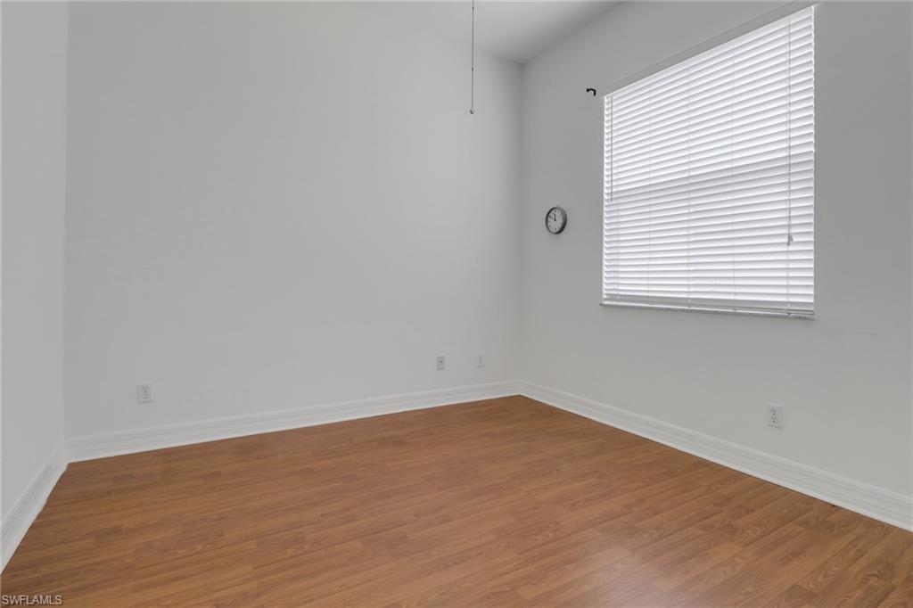3283 Potomac Court Naples, FL 34120 - Photo 17 of 29 Unfurnished room with baseboards and wood finished floors