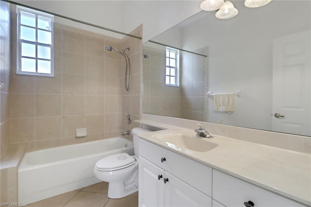 3283 Potomac Court Naples, FL 34120 - Photo 18 of 29 Full bath featuring plenty of natural light, bathtub / shower combination, toilet, and tile patterned flooring