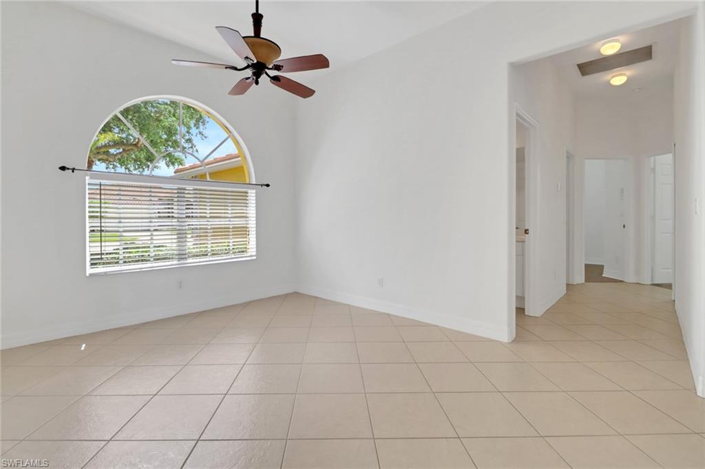 3283 Potomac Court Naples, FL 34120 - Photo 3 of 29 Spare room with a ceiling fan, light tile patterned flooring, and baseboards