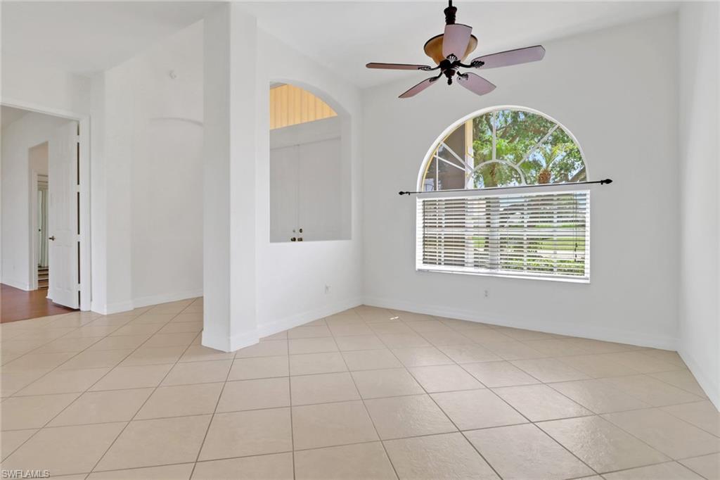 3283 Potomac Court Naples, FL 34120 - Photo 4 of 29 Unfurnished room with a ceiling fan, light tile patterned floors, and baseboards