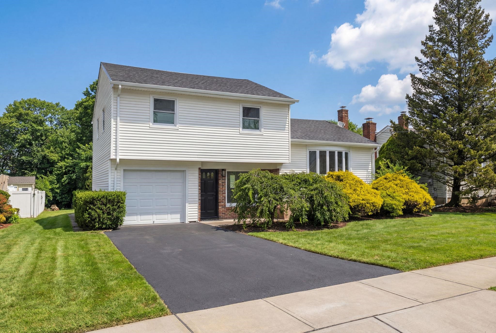 a front view of a house with a garden