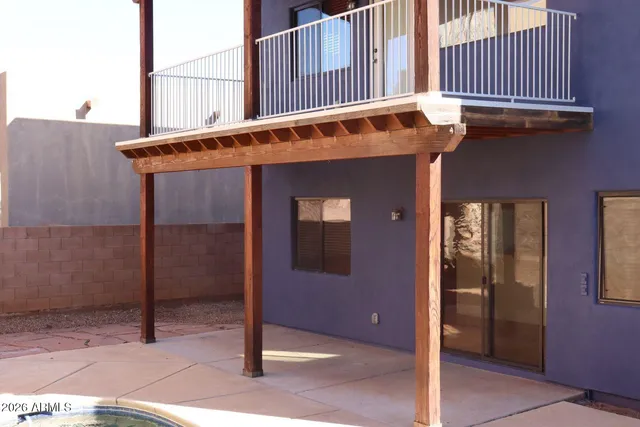 a view of a house with a door and wooden fence
