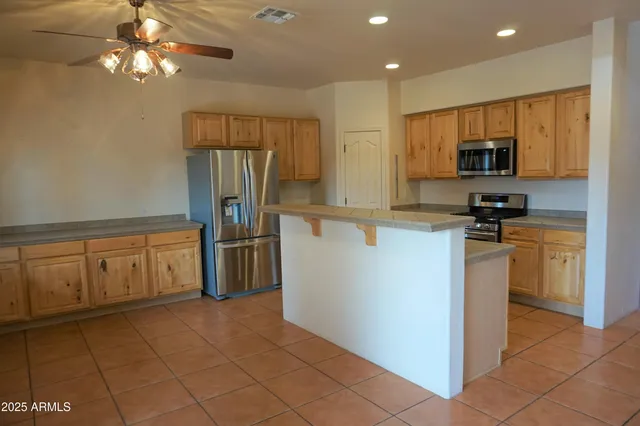 a kitchen with a refrigerator sink and cabinets