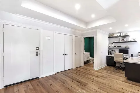a view of a kitchen with fridge and wooden floor