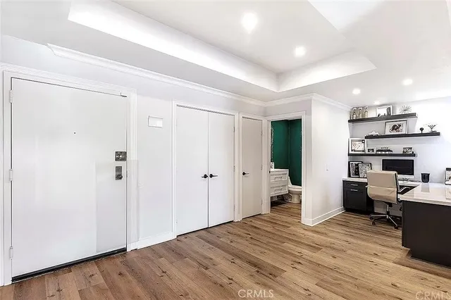 a view of a kitchen with fridge and wooden floor