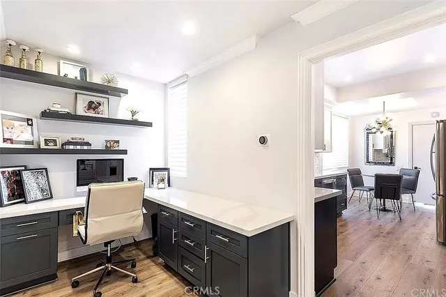 a view of a kitchen with a dining table chairs and a refrigerator