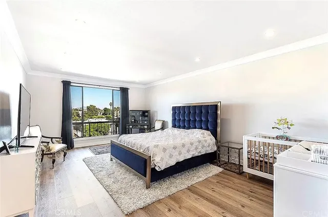 a bedroom with a bed and a dresser in it