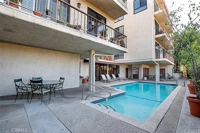a view of a house with swimming pool and sitting area