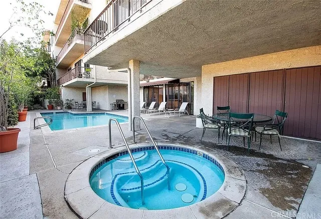 a view of a house with swimming pool and sitting area