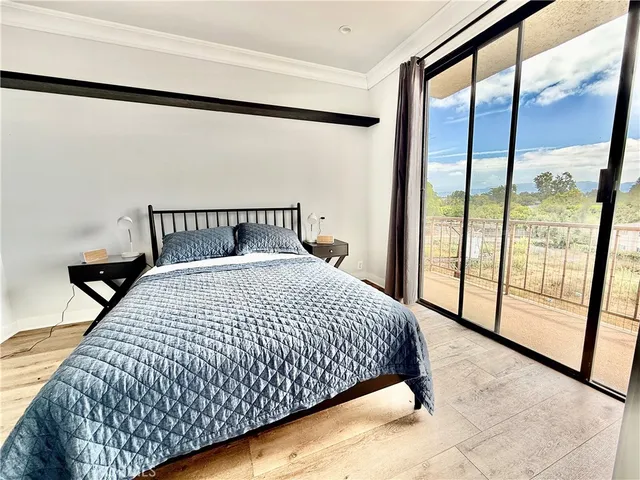 a large bed sitting in a bedroom next to a window