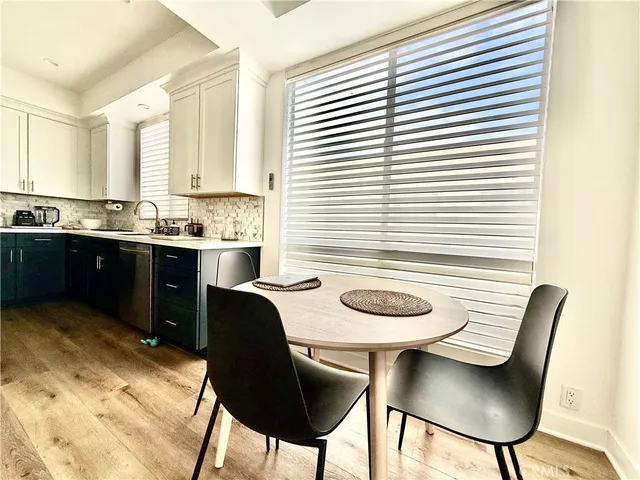 a kitchen with a table chairs stove and sink