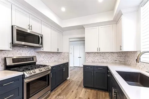 a kitchen with a sink stove and microwave