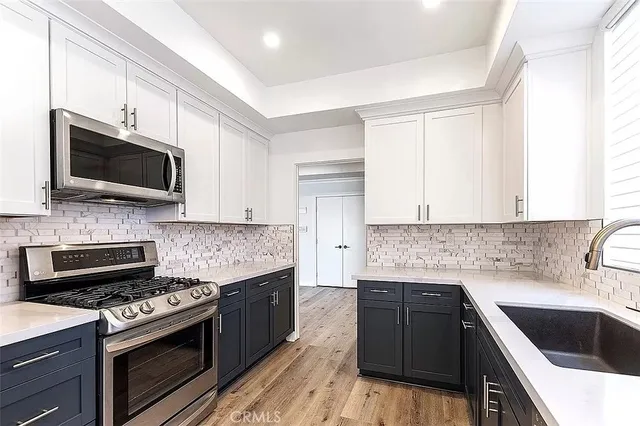 a kitchen with a sink stove and microwave