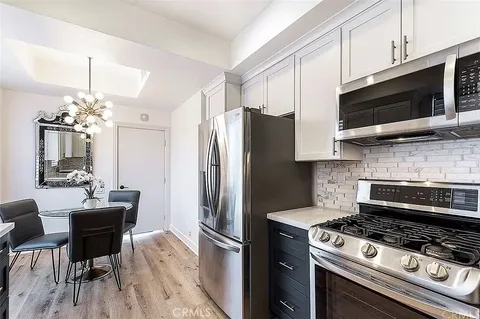 a kitchen with stainless steel appliances a stove a microwave and a counter top space