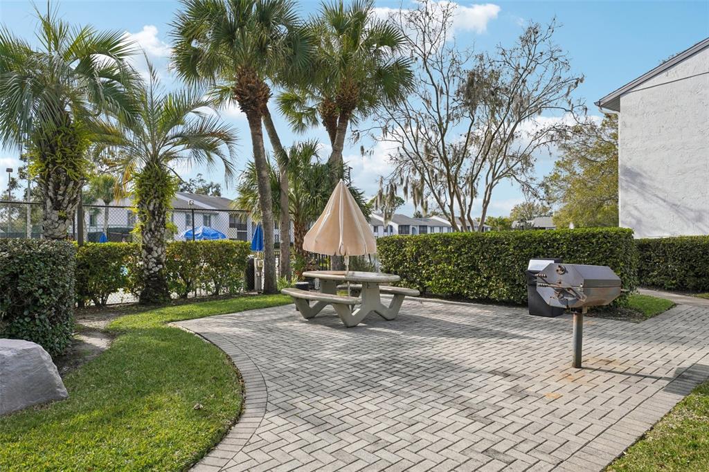 1344 Pine Ridge Circle East, Unit E3 Tarpon Springs, FL 34688 - Photo 19 of 25 a garden view with a seating space