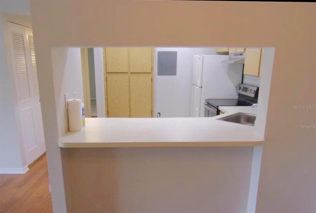 1344 Pine Ridge Circle East, Unit E3 Tarpon Springs, FL 34688 - Photo 3 of 25 a bathroom with a sink and a refrigerator