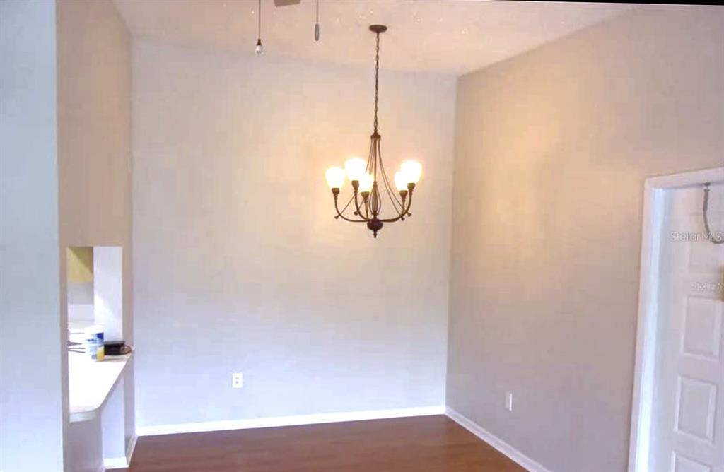 1344 Pine Ridge Circle East, Unit E3 Tarpon Springs, FL 34688 - Photo 4 of 25 a view of a room with wooden floor