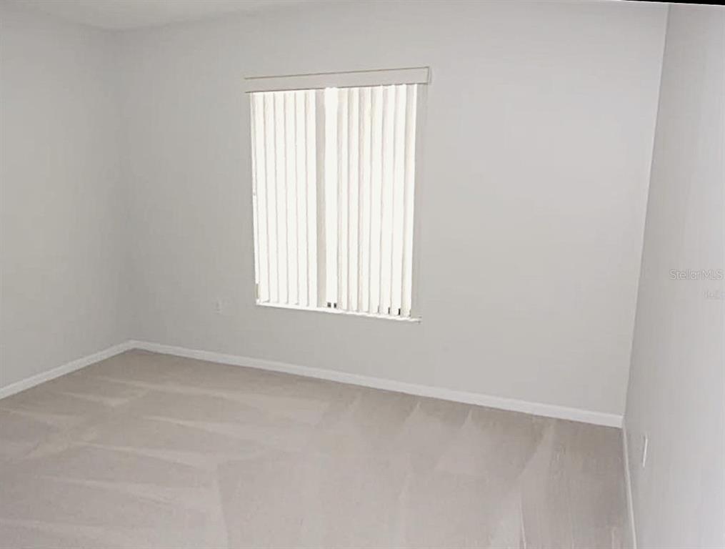 1344 Pine Ridge Circle East, Unit E3 Tarpon Springs, FL 34688 - Photo 6 of 25 an empty room with a window