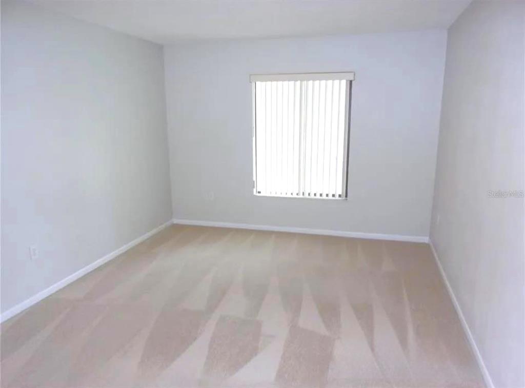 1344 Pine Ridge Circle East, Unit E3 Tarpon Springs, FL 34688 - Photo 9 of 25 an empty room with a window