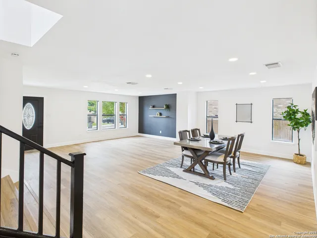 a view of a dining room with furniture and a potted plant