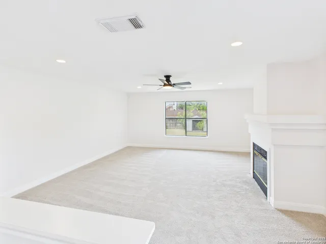 an empty room with windows and entrance