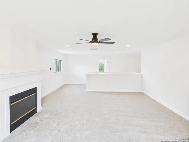 a view of an empty room with a fireplace