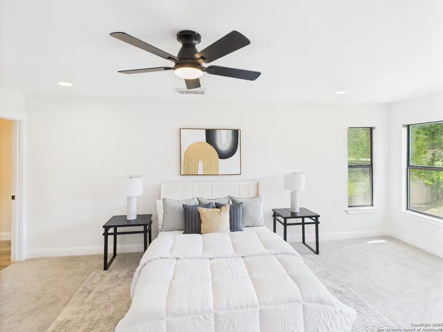 a bedroom with a bed and a lamp next to a window