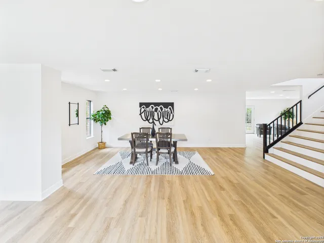 a view of a room with wooden floor and table