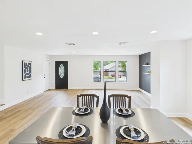 a view of table and workspace with wooden floor