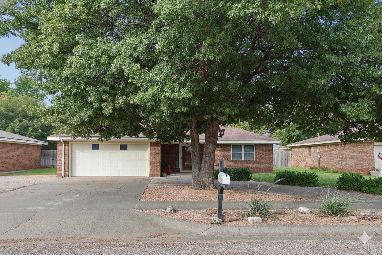 6108 Cornell Street Amarillo, TX 79109 - Photo 1 of 26 a front view of a house with garage and plants