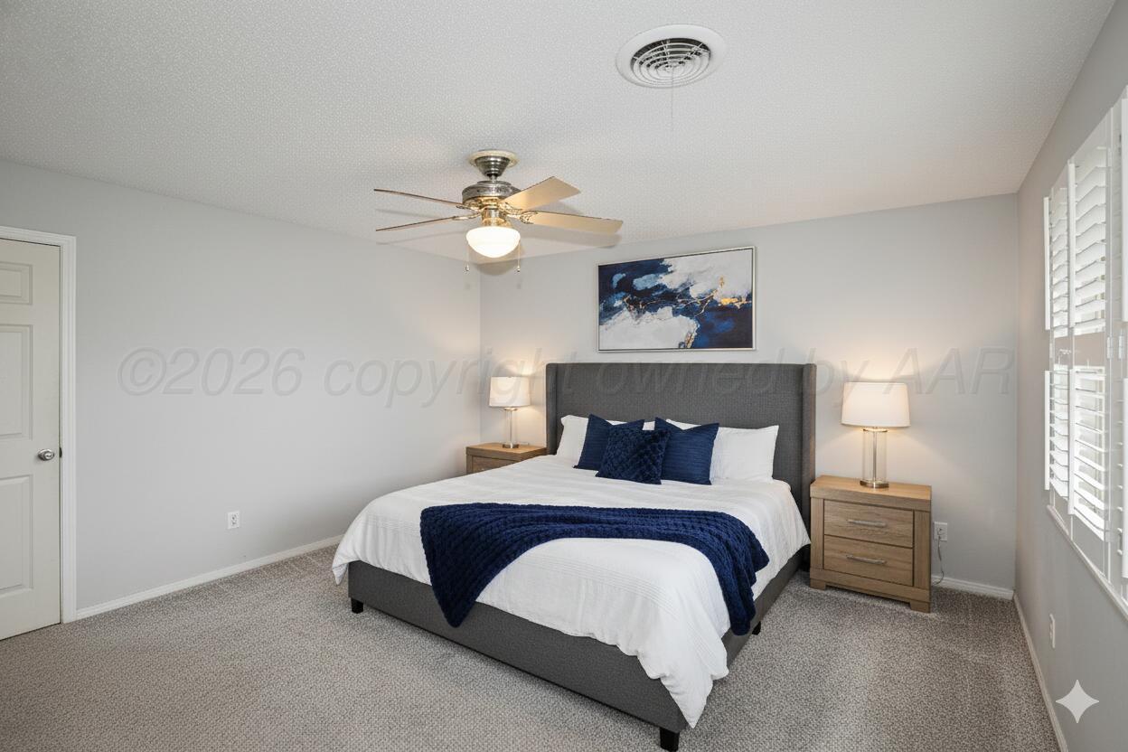 6108 Cornell Street Amarillo, TX 79109 - Photo 13 of 26 a bedroom with a bed and a chandelier