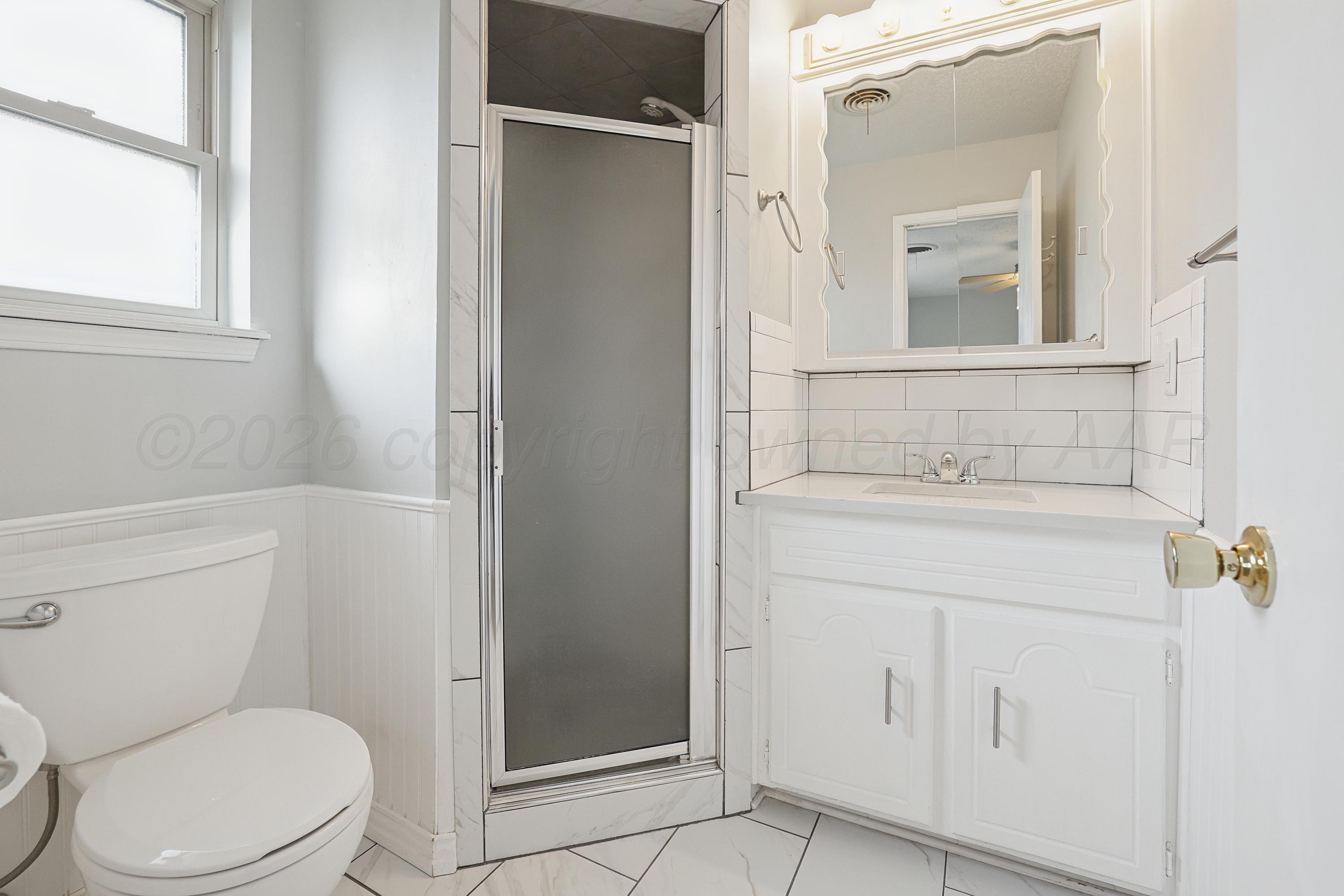 6108 Cornell Street Amarillo, TX 79109 - Photo 15 of 26 a bathroom with a sink a toilet and shower