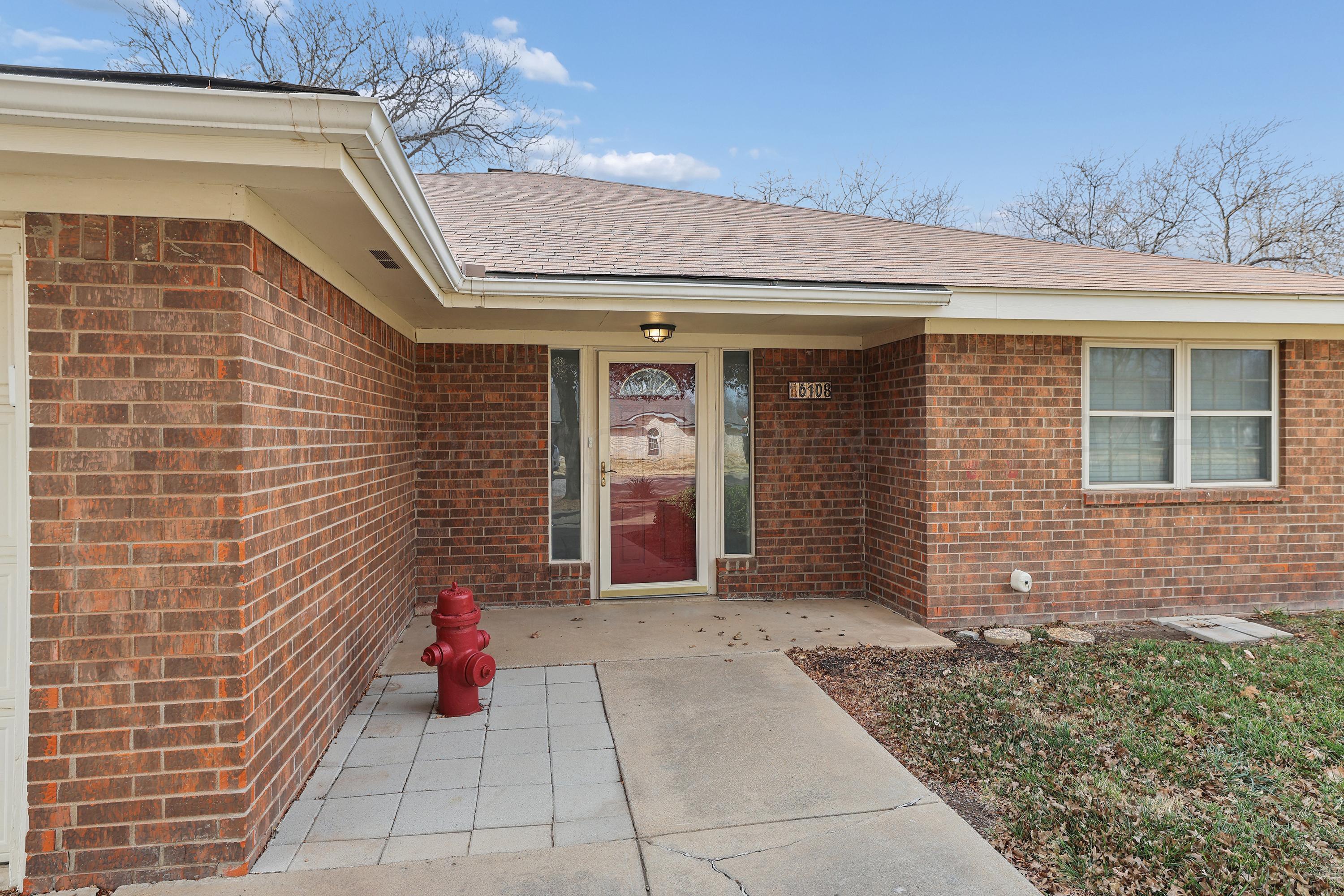 6108 Cornell Street Amarillo, TX 79109 - Photo 2 of 26 a view of a brick house with large windows